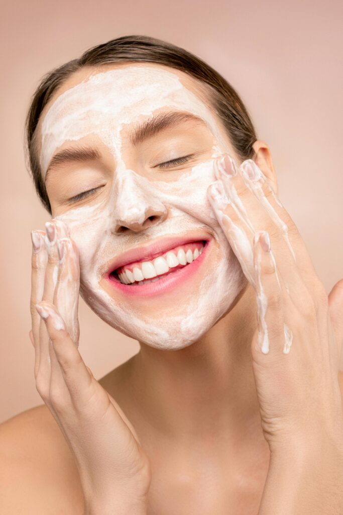 pexels photo 3762466 3762466 Smiling woman applies facial wash while enjoying her skincare routine, promoting happiness and skin health.