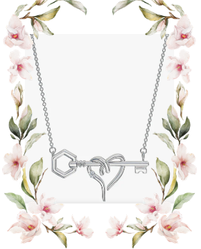 Heart and hexagon key diamond necklace in sterling silver, styled with a soft floral border.