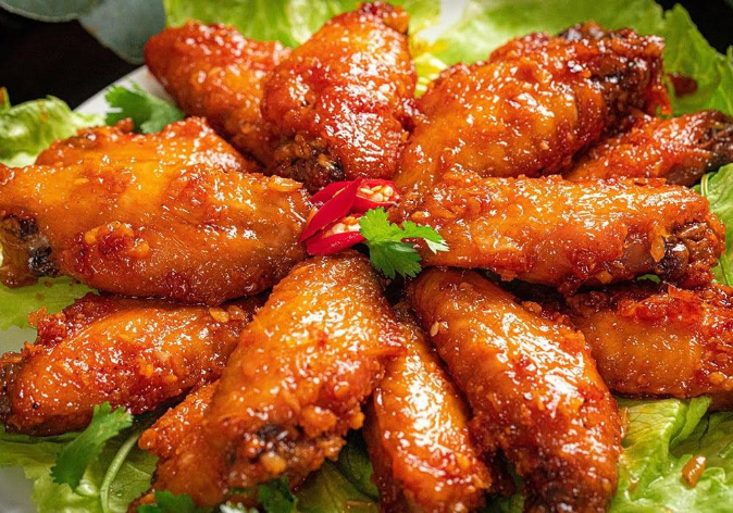 Crispy Vietnamese fish sauce chicken wings coated in garlic chili sauce served fresh on a plate